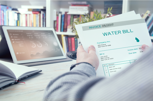 Homeowner looking at water bill in Washington D.C. home office.
