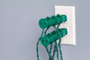 Stacked holiday lights plugged into one outlet